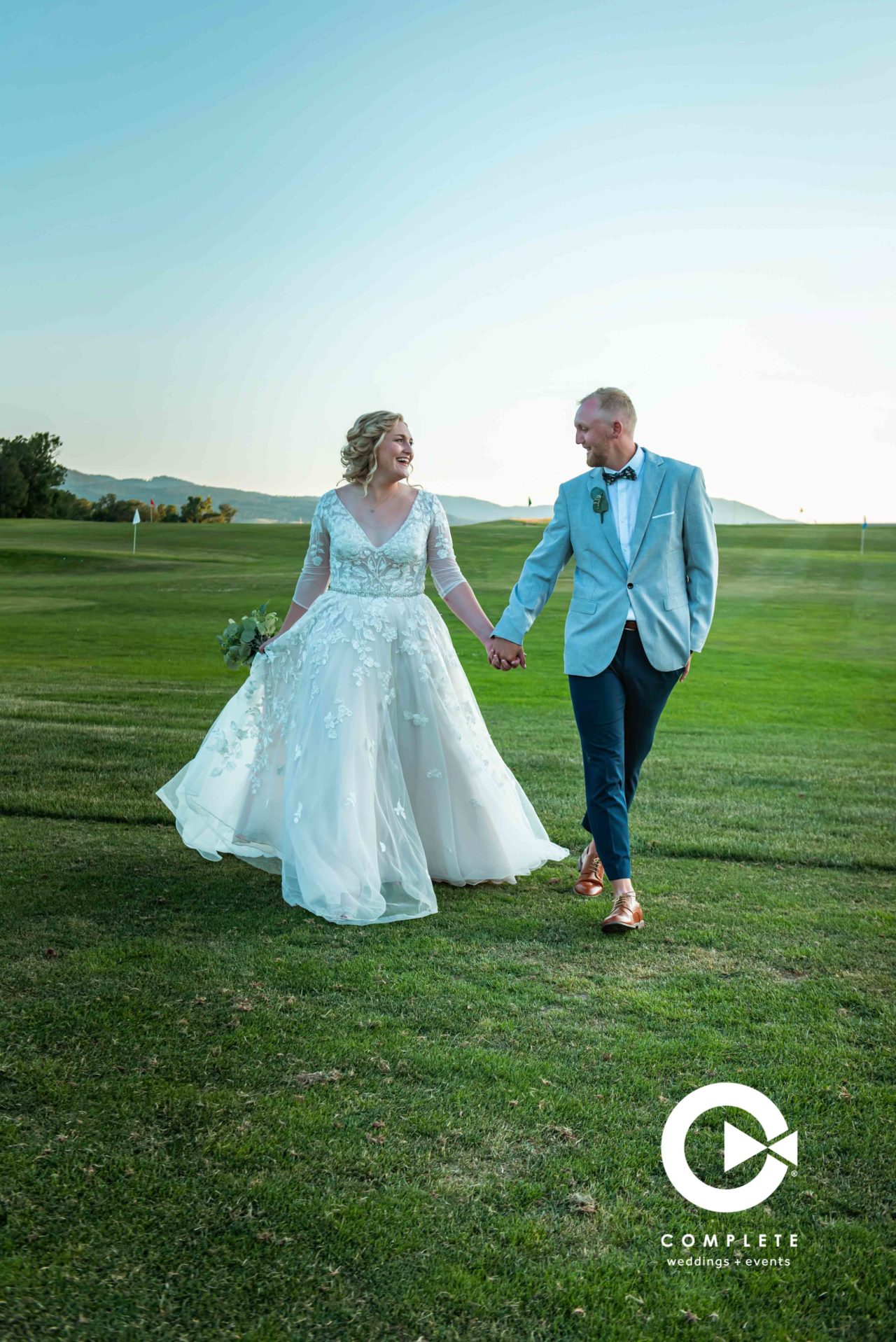 Bride and groom walking in a field South Dakota wedding
