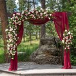 Wedding ceremony arch decorated with live flowers
