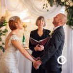 Officiant, bride and groom during wedding ceremony