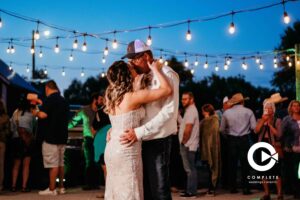Bride and groom kissing on the dance floor during first dance