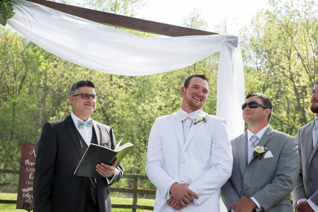 Groom Smiles when he sees his Bride on the Lawn Ceremony at the Mayowood Stone Barn in Rochester, MN