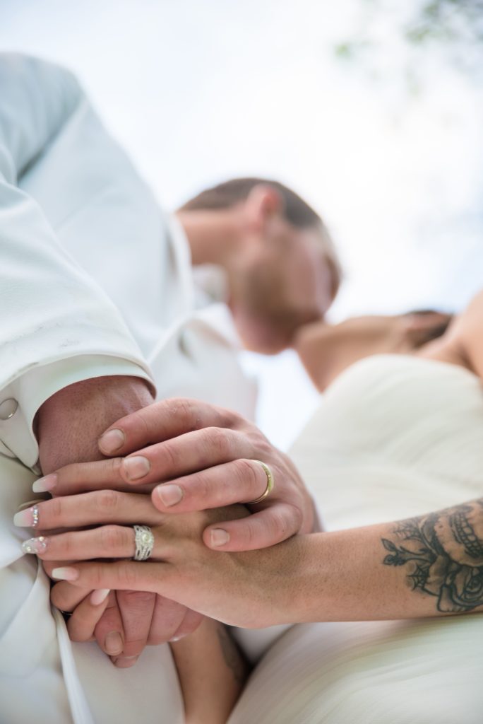 Hands with Wedding Ring Photo with Bride and Groom Kiss