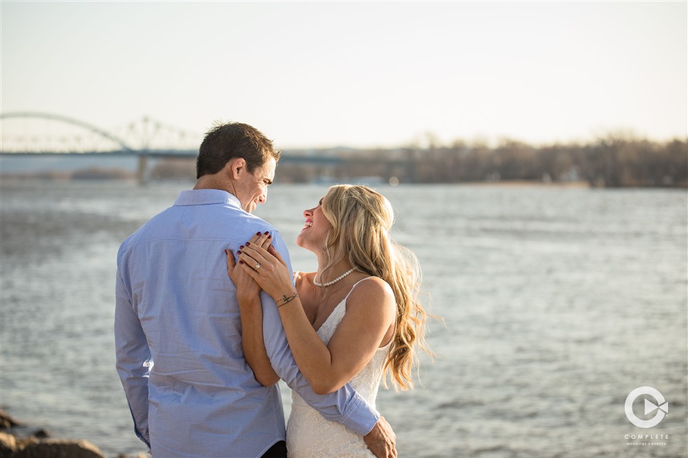 engaged couple by lake