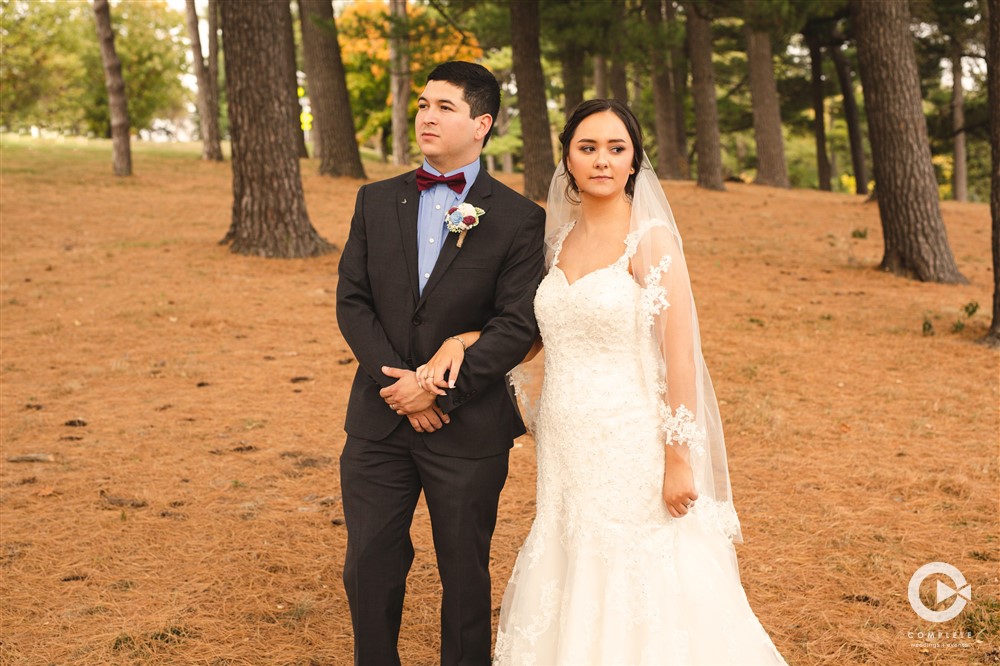 Fall wedding in Rochester bride and groom stand in the Fall weather