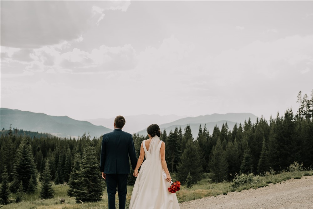 couple looking over mountain scenery on wedding day