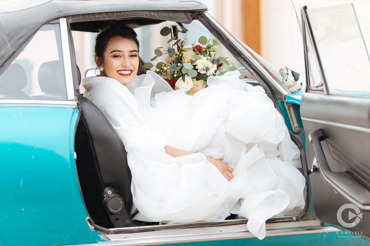 bride in car Sustainable Wedding