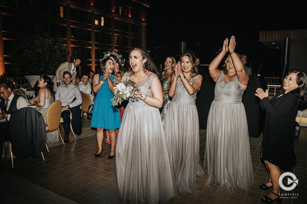 bridemaid catches bouquet