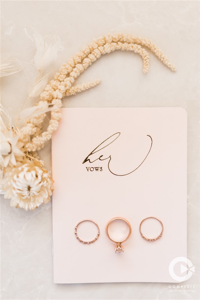 her vows booklet and wedding rings