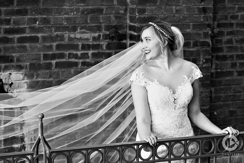 bride in front of brick