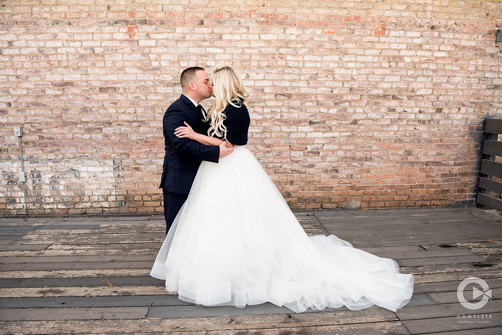 couple in front of brick