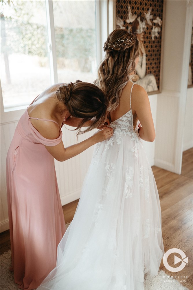 bride putting on her dress
