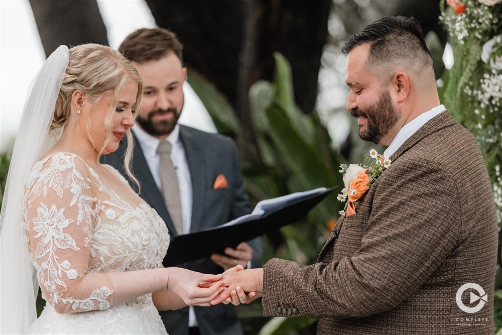 bride and groom exchanging rings