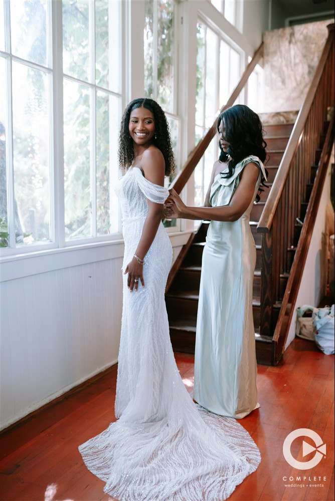 bride putting on dress