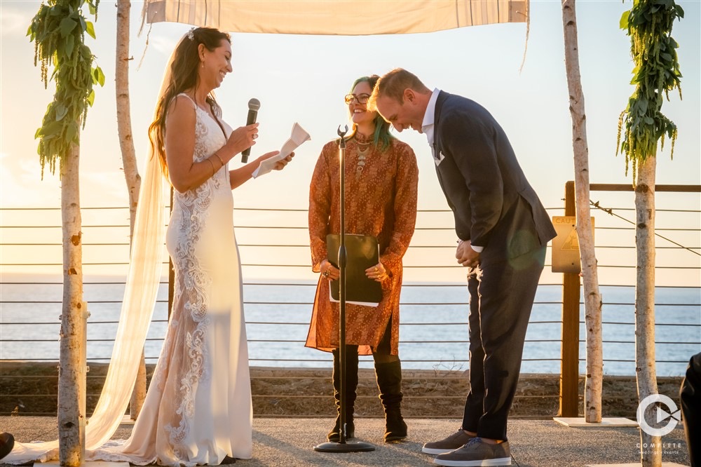 bride reading vows at wedding ceremony