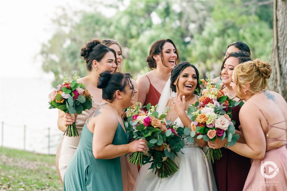 bride and bridesmaids in colorful satin dresses
