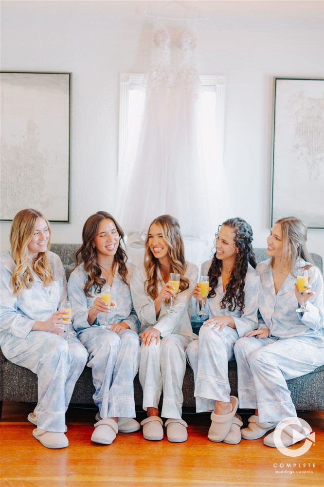 bridesmaids and bride sipping mimosas