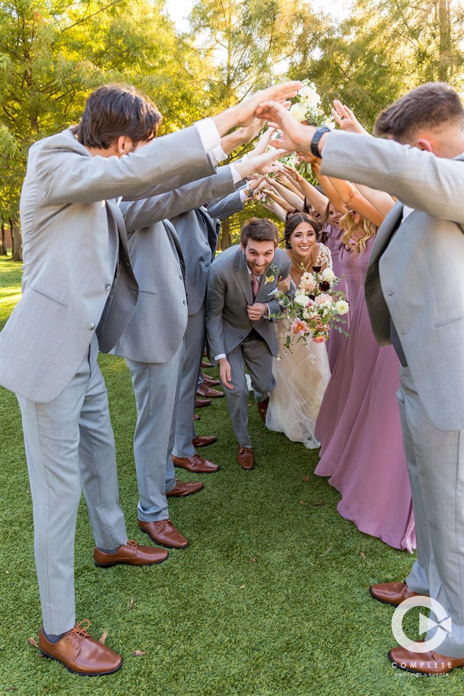 tunnel walk wedding party photos