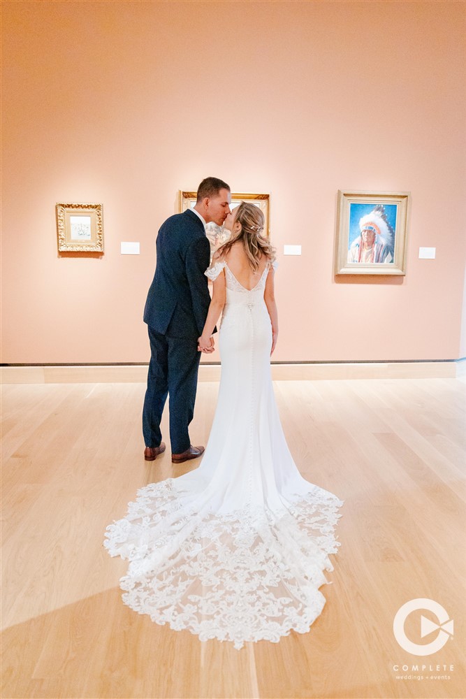 Bride and Groom Kiss in Art Museum