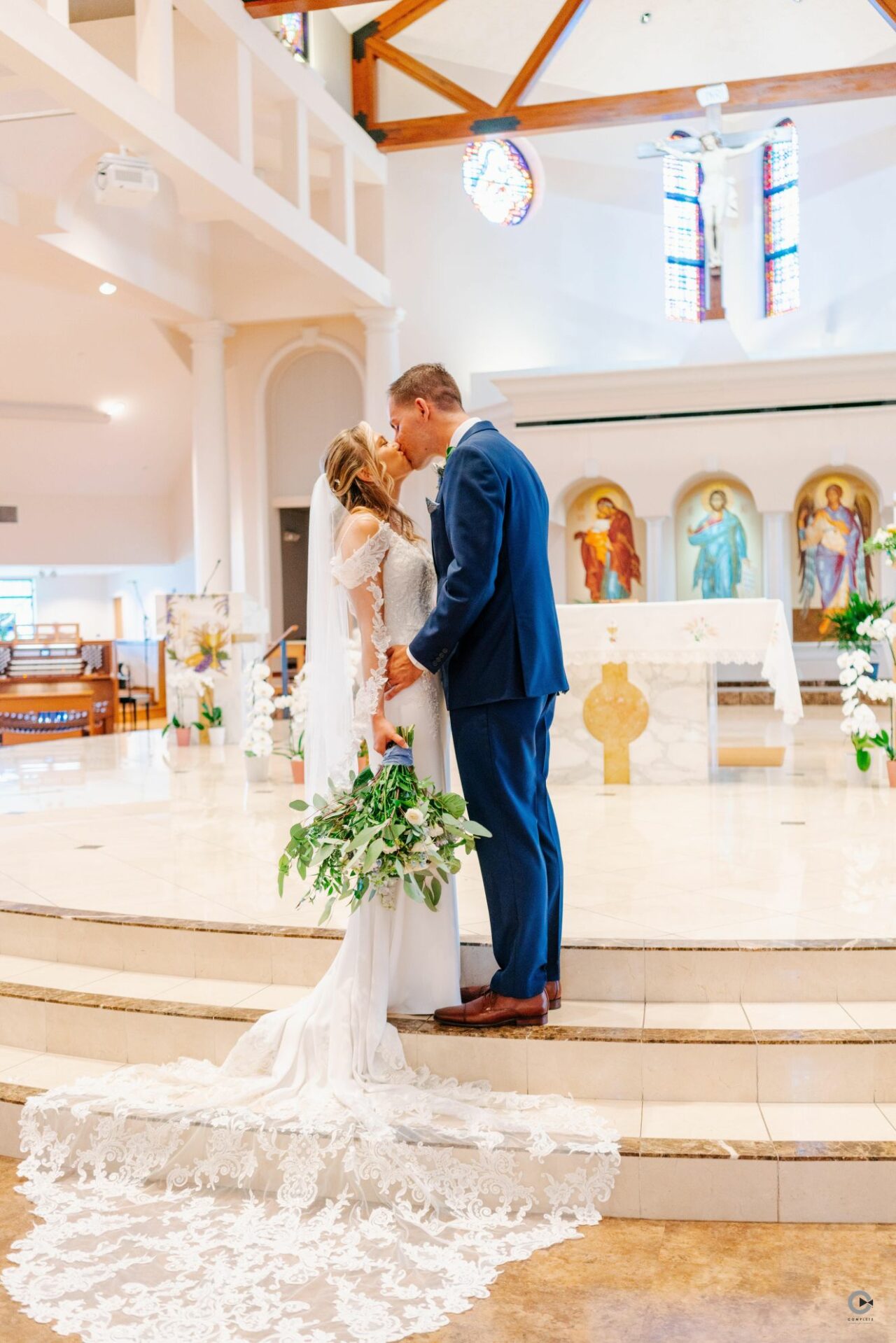Bride and Groom Kissing in front of Altar
