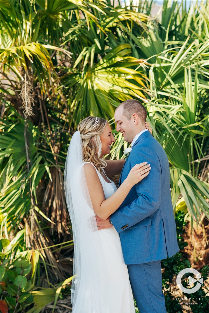 Bride and groom embrace outdoors at Zota Beach Resort