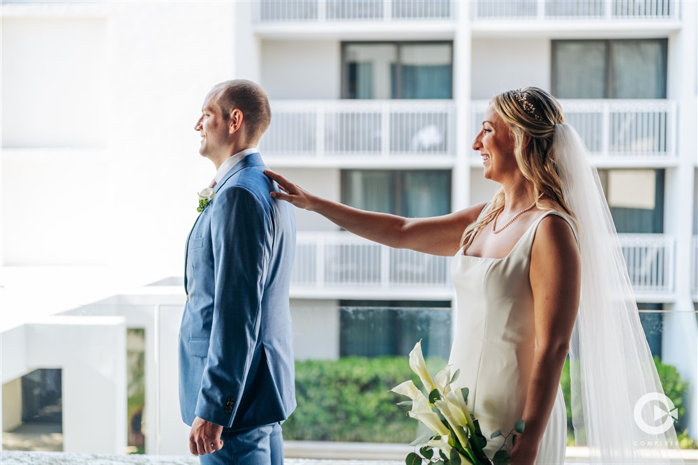 bride taps Groom's shoulder for first look