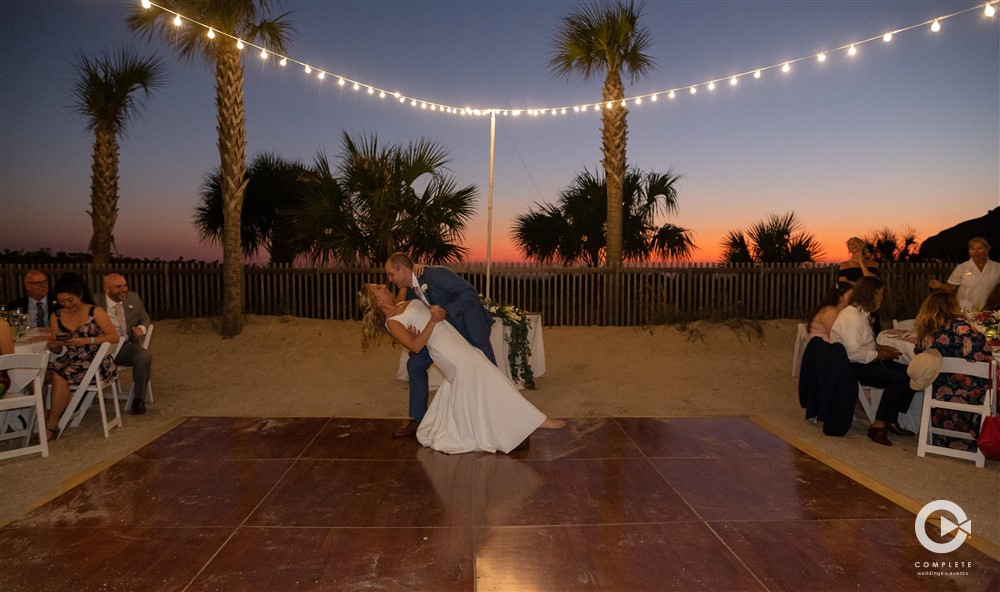 Groom dips bride during first dance at Zota Beach Resort