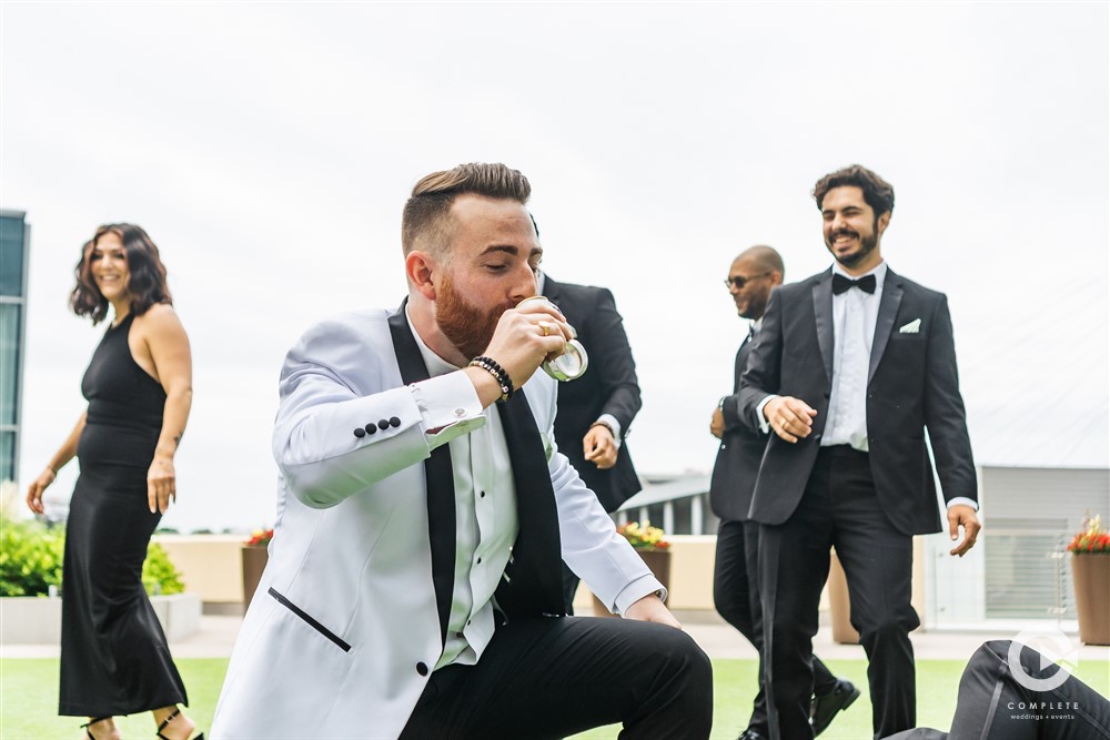 Guy chug-a-lugs a drink at a bachelor party in Sarasota