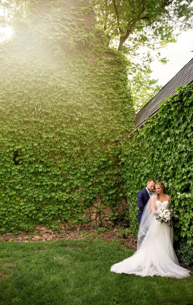Bride and groom portrait in front of ivy wall at Haseltine Estates