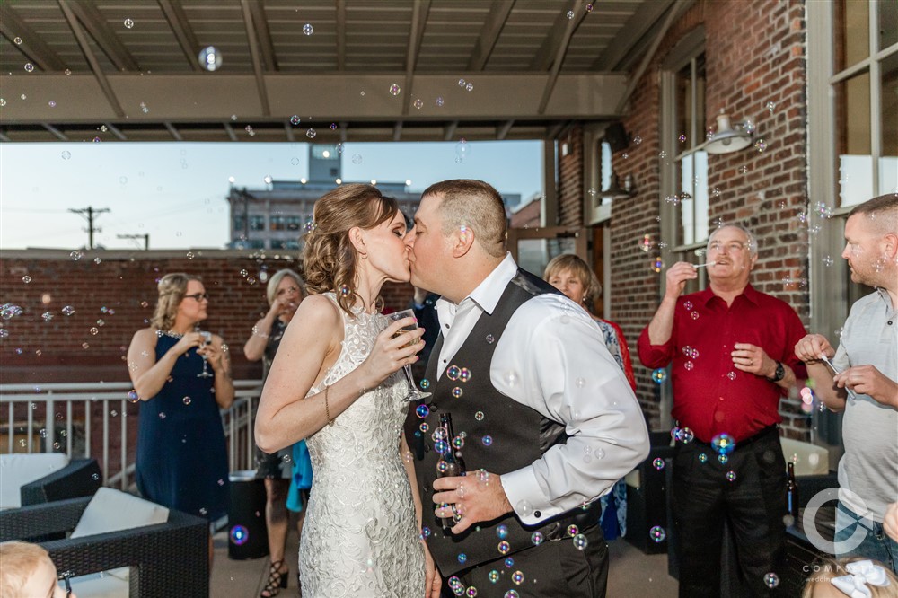 Sarah + Jason Bubble exit bride and groom kissing