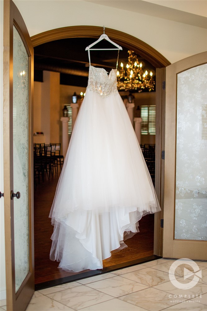 Wedding Dress hanging in doorway