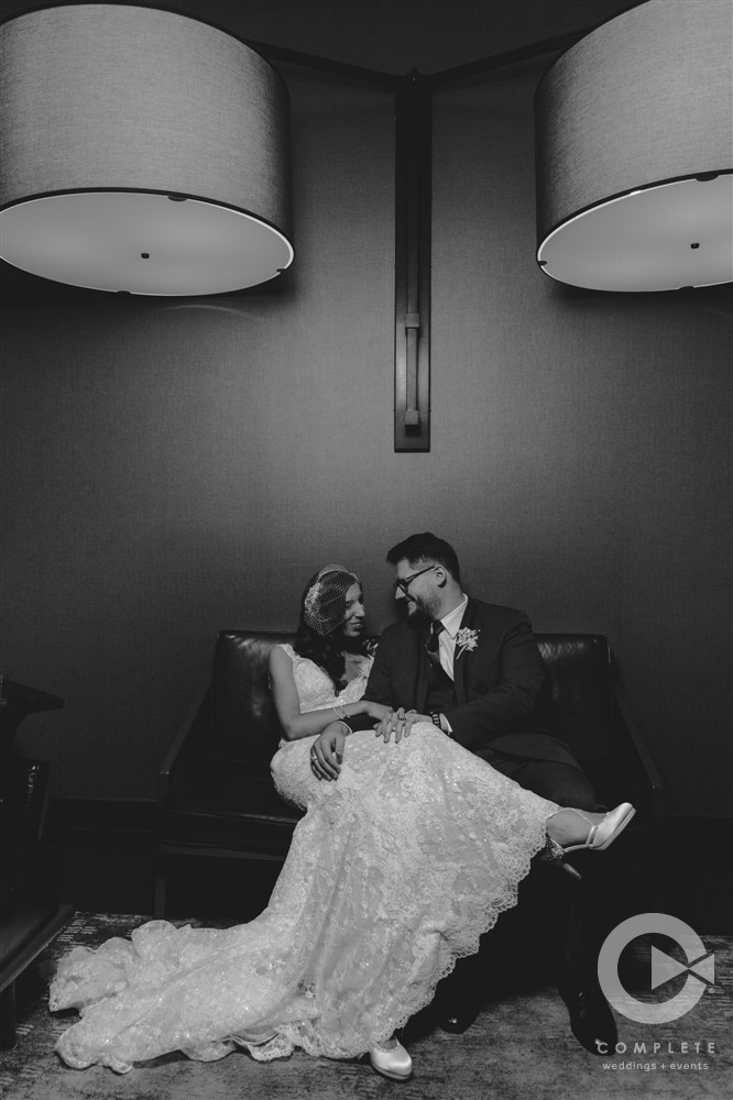 Bride and Groom snuggled up in Hotel Vandivort's Lobby