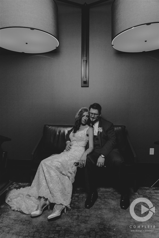 Dark and moody pictures of bride and groom snuggling on couch