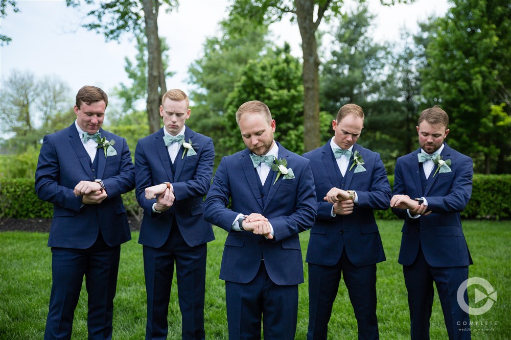 groom and groomsmen looking at there watch