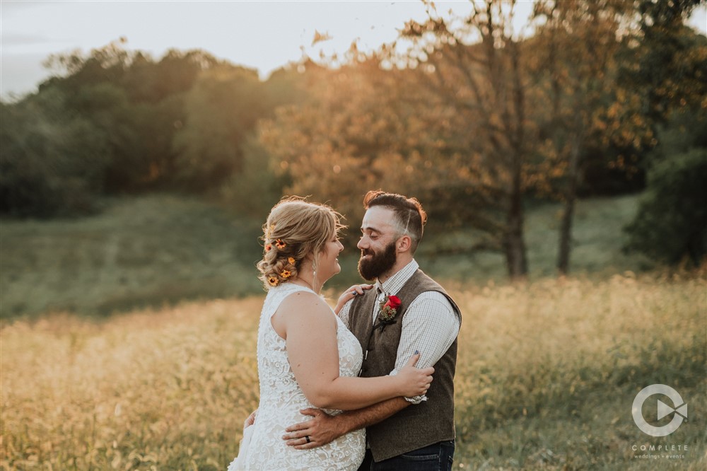 bride and groom looking at each other at sunset