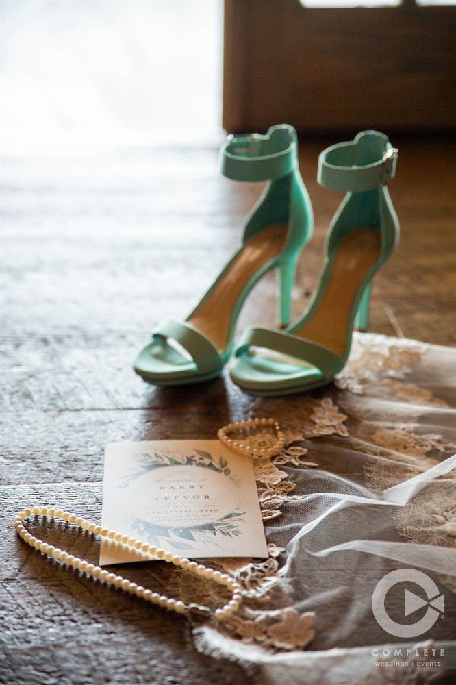 brides shoes with wedding card and necklace