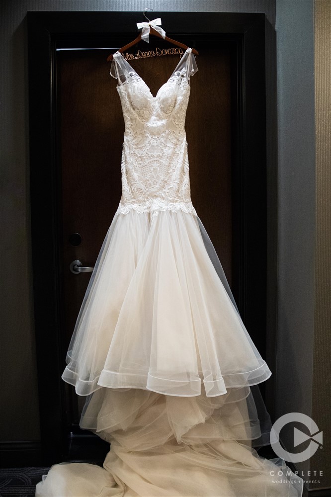 bridal gown hanging in doorway