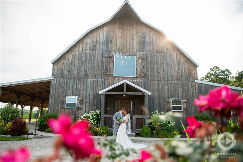 Darby + Trevor bride and groom in front of gambrel barn