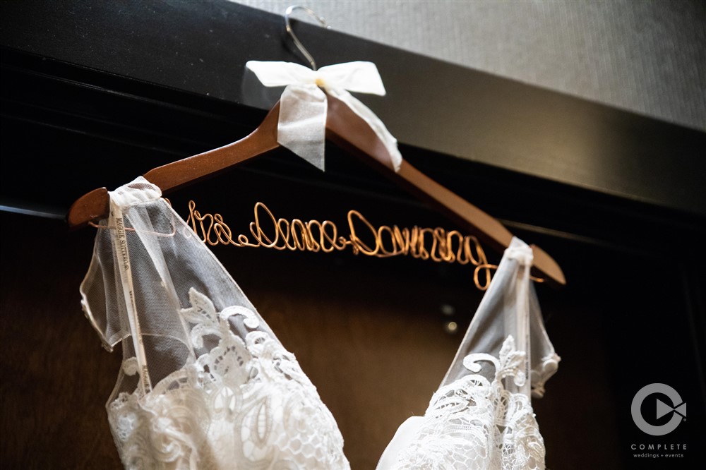 Alexis & Taiyler brides dress hanging on custom hanger