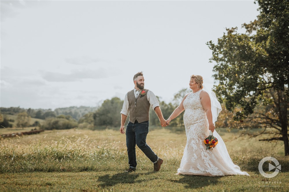 groom continuing to lead bride into field