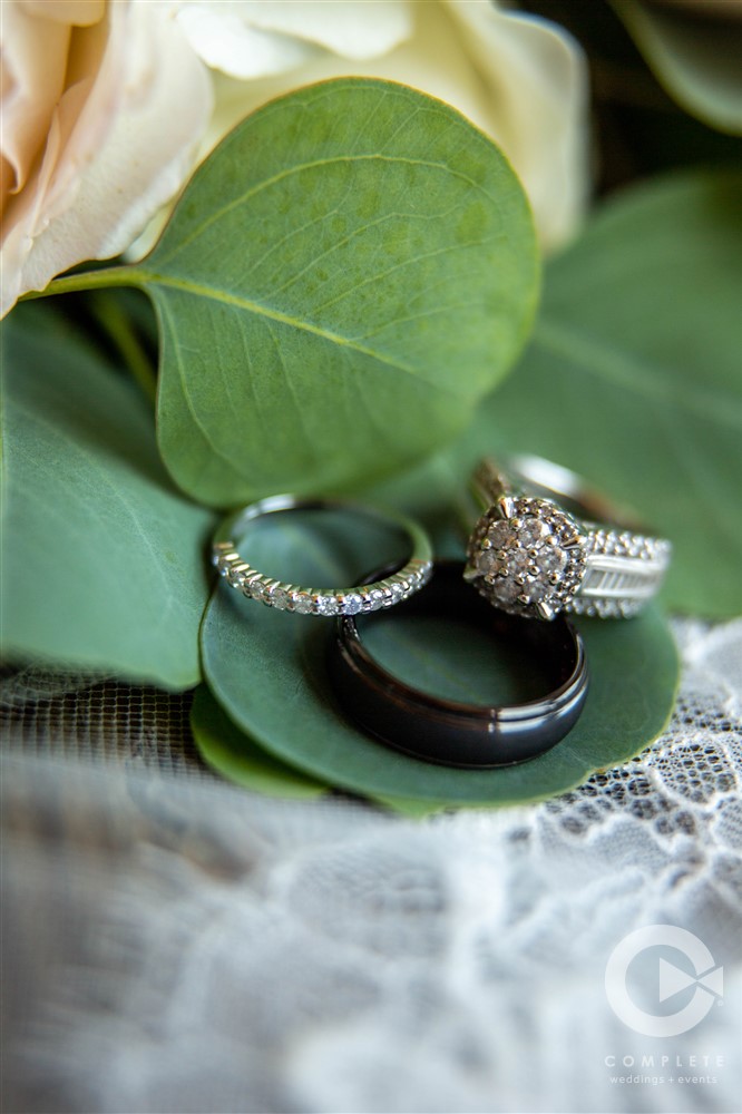 wedding rings macro with bouquet and lace