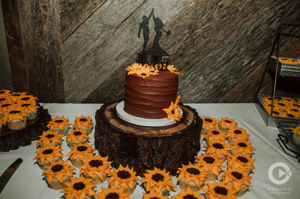 wedding cake with sunflower cupcakes