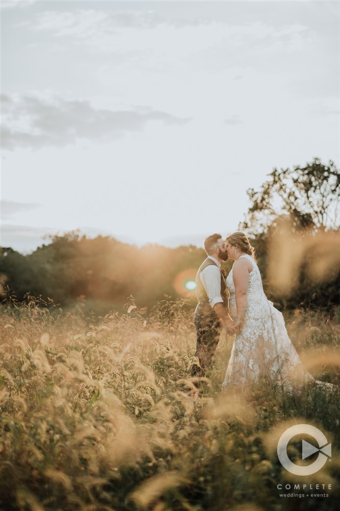 bride and groom kiss at sundown