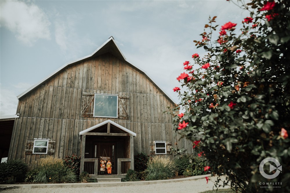 gambrel barn exterior with flowering plant