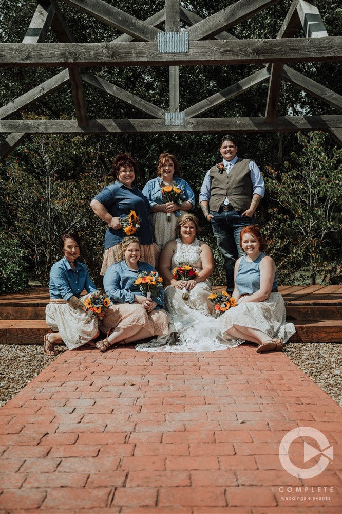 bride and bridesmaids sitting at altar