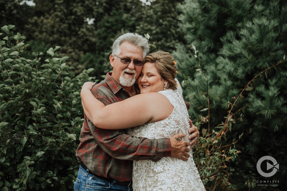 bride and dad hug