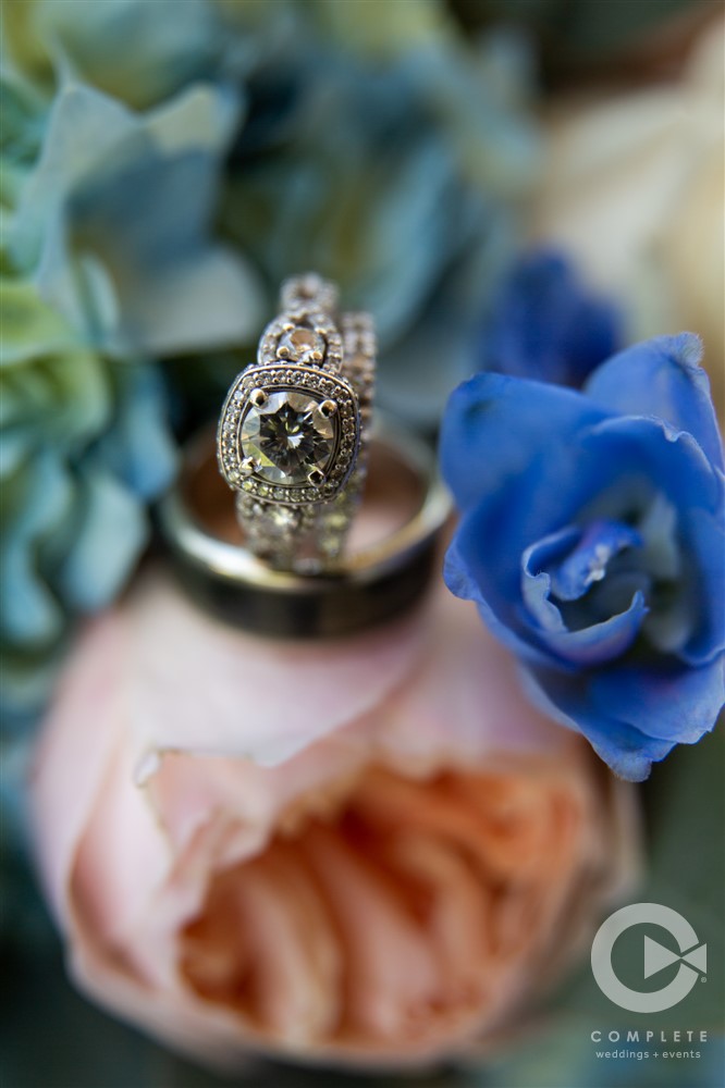 macro wedding rings on top of bouquet