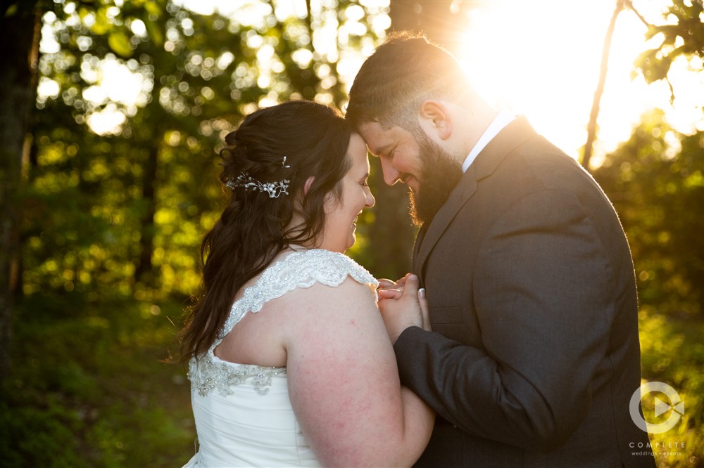 bride and groom loving head bump at sunset