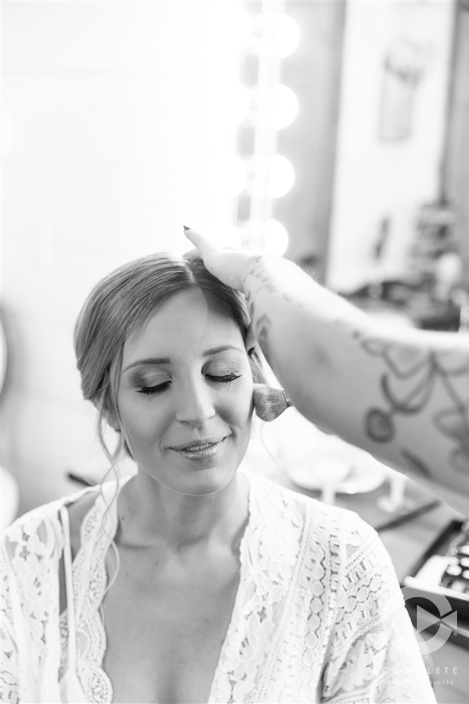 bride having makeup done before ceremony