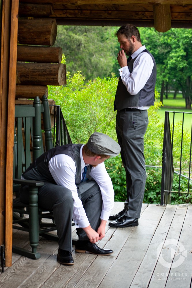 groom puts on shoes before ceremony