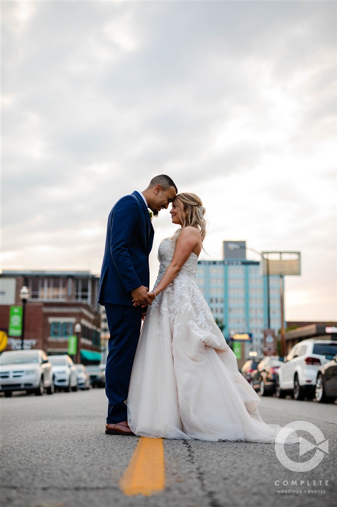 bride and groom head bump in front of downtown springfield